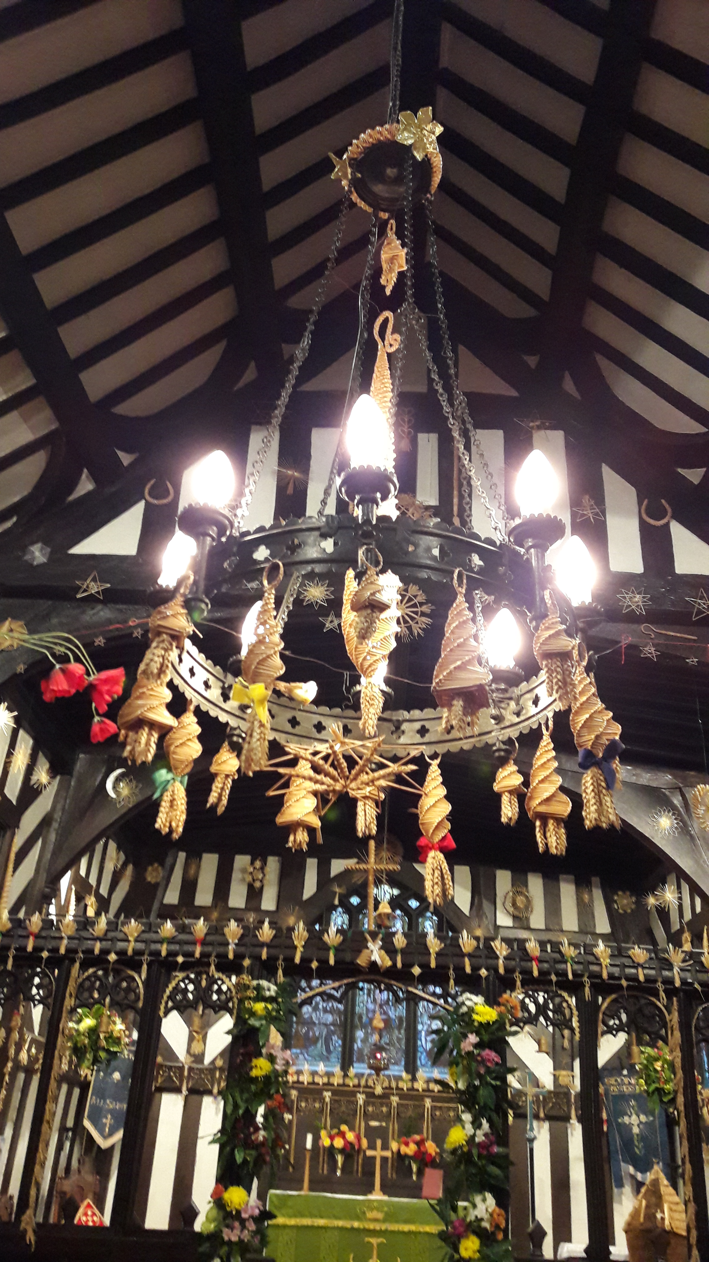 The chandelier at All Saints, Siddington decorated with corn dollies.